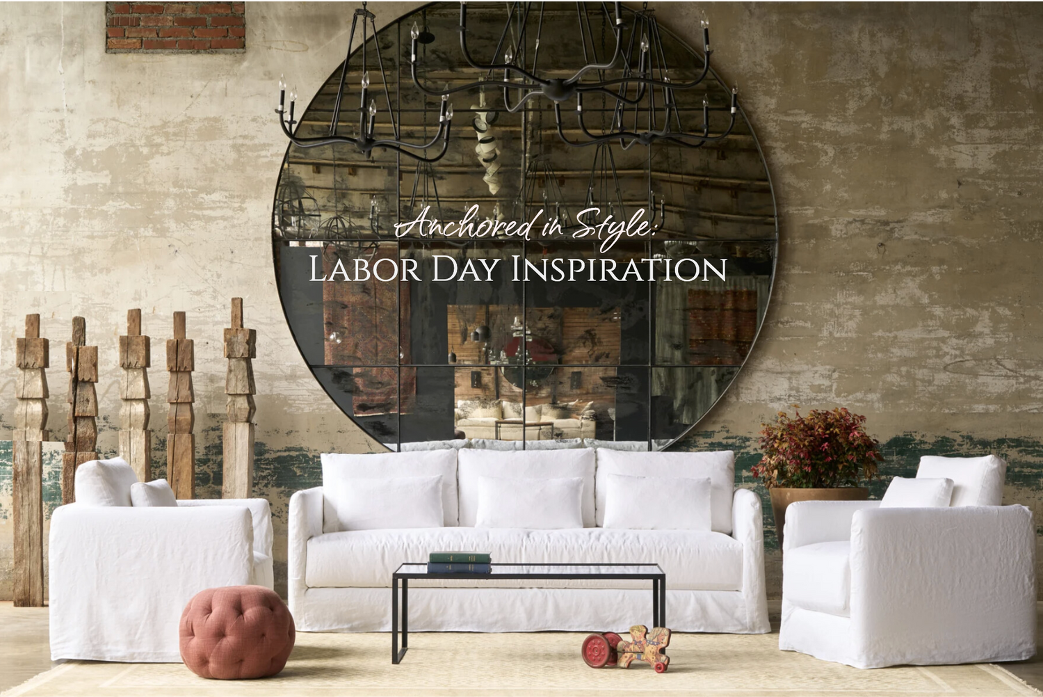 Living room with white furniture and a large circular mirror on the wall.