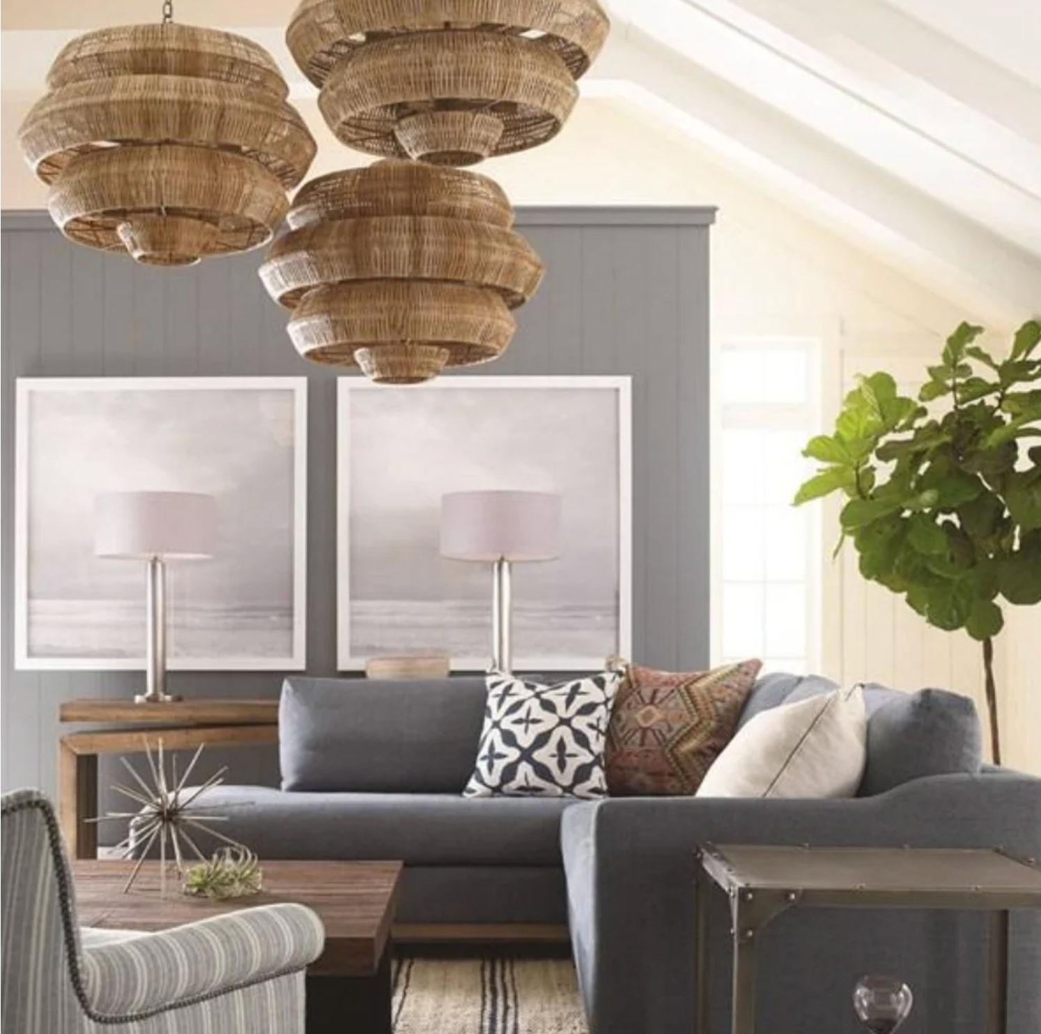 Living room with Marseille Rattan chandelier, gray sofa, and jute ticking rug from Our Boat House.