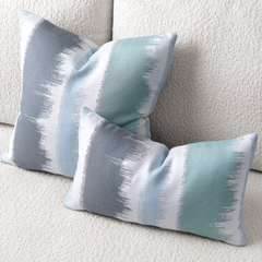 blue and white abstract throw pillow styled in coastal living space lifestyle