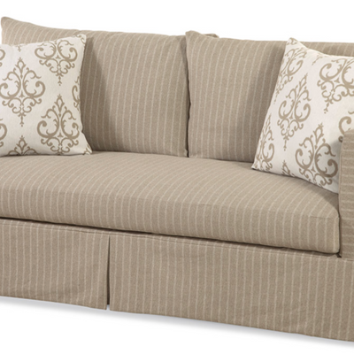 Beige sofa with patterned cushions on a white background