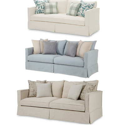 Beige sofa with patterned cushions on a white background