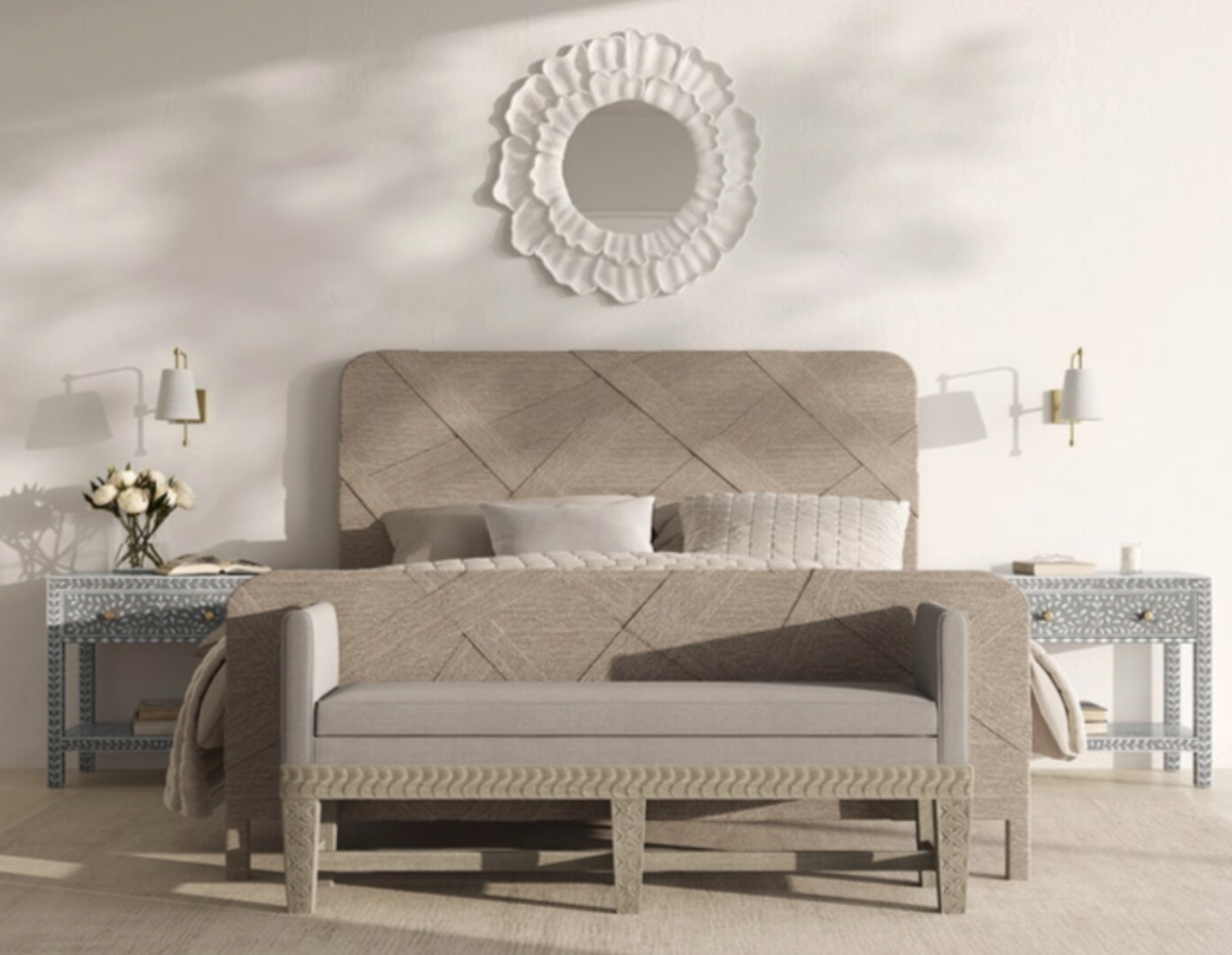 Neatly made bed with a decorative headboard and bench in a bedroom setting.