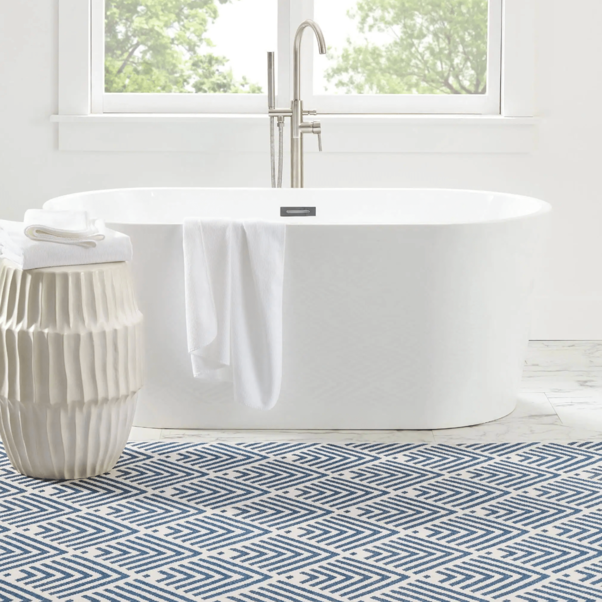 navy machine washable rug styled in bright coastal interior lifestyle