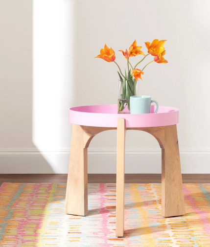 Colorful coastal rug with pink side table and fresh tulips – Our Boat House vibrant style