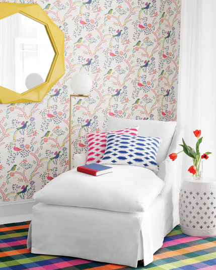 White slipcovered chaise with colorful pillows in a bright coastal room – Our Boat House