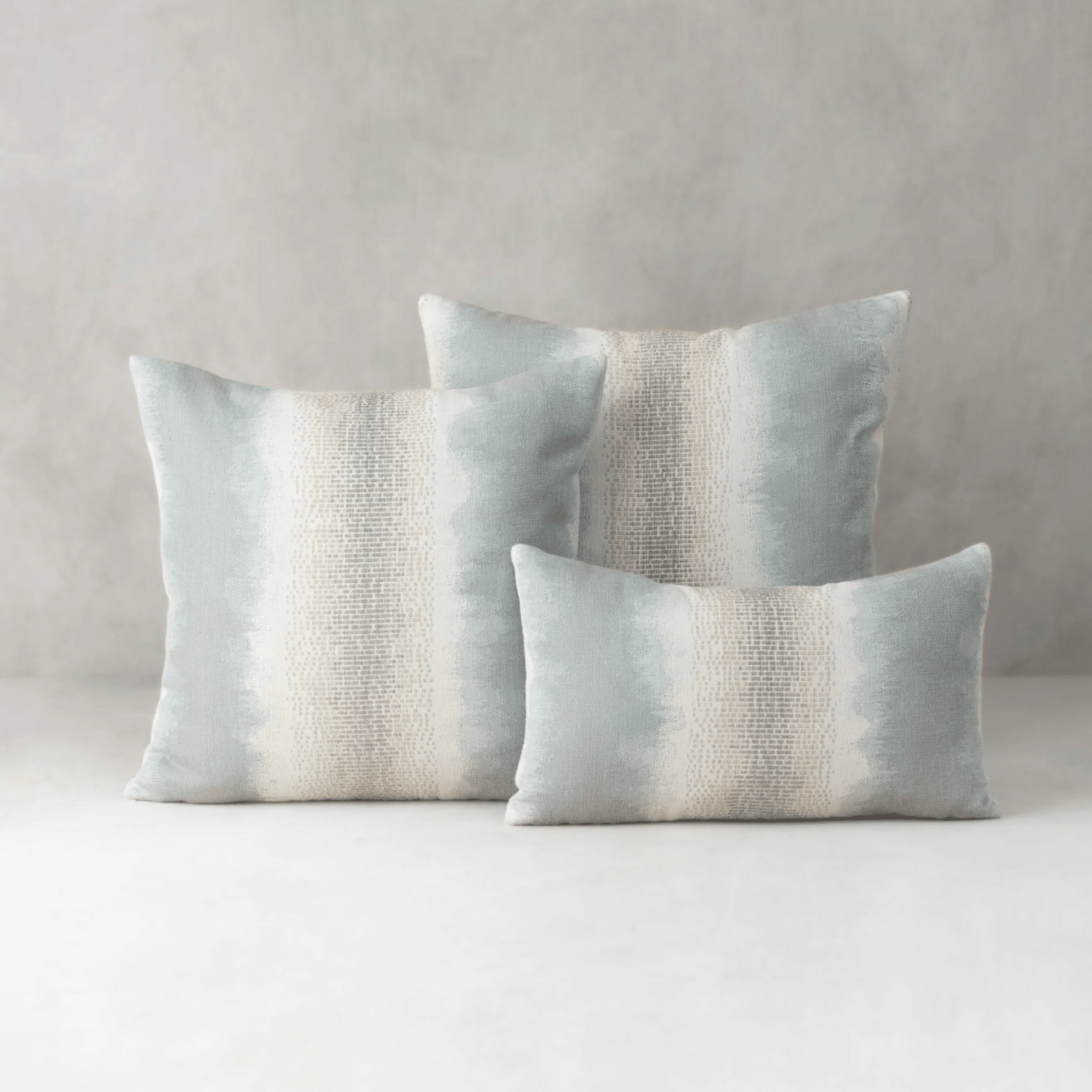 sky blue tides indoor outdoor pillow styled on sofa in coastal living room lifestyle