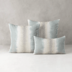 sky blue tides indoor outdoor pillow styled on sofa in coastal living room lifestyle